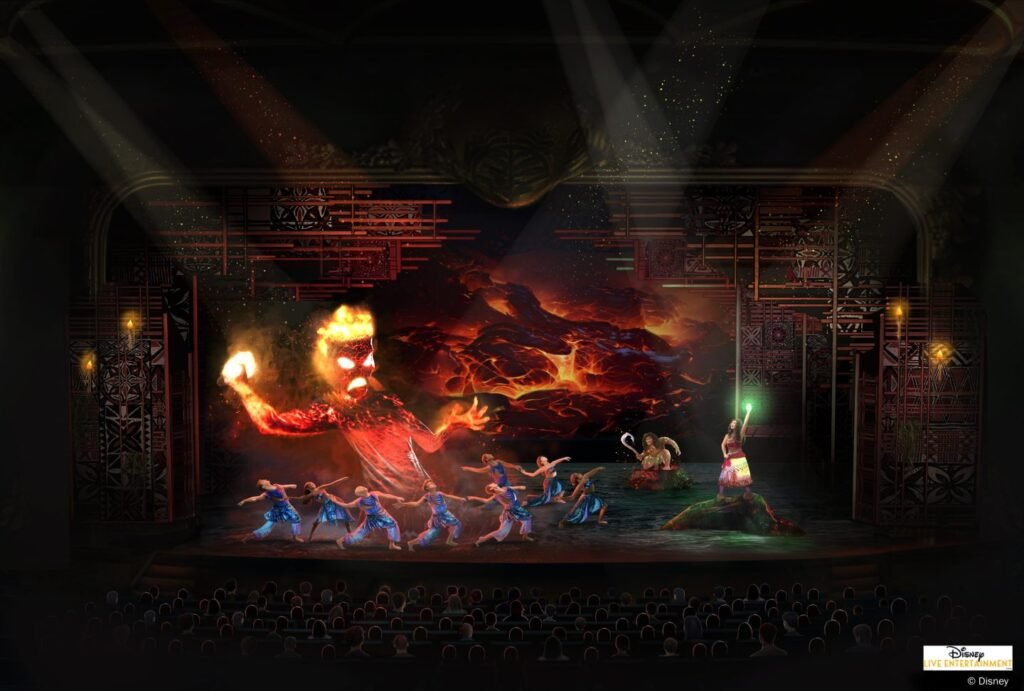Animated performance onstage featuring dancers in blue costumes and a large fiery character in the background with a volcanic scene, while another character stands on the right holding a green-glowing staff.