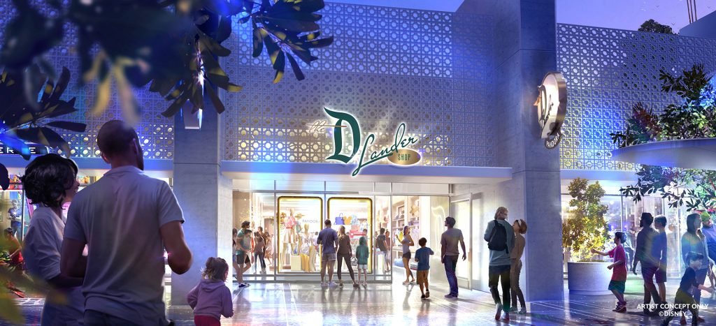 People walking and interacting in front of the illuminated entrance to The Disneylander Shop at night.
