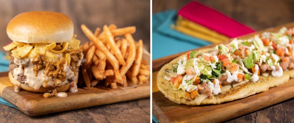 A loaded burger with Fritos and a side of fries on one plate, and a garnished flatbread with toppings including lettuce, tomato, and sour cream on another plate.