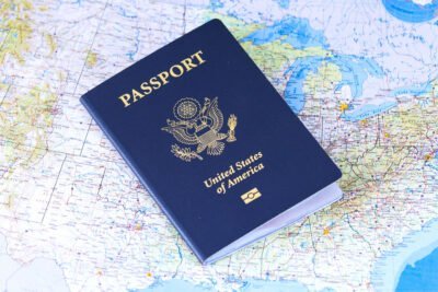 A U.S. passport is placed on a detailed map of North America.