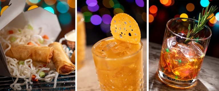 Two spring rolls next to a container of noodles, a cocktail with a yellow garnish, and a mixed drink with a sprig of rosemary, set against a backdrop of colorful bokeh lights.
