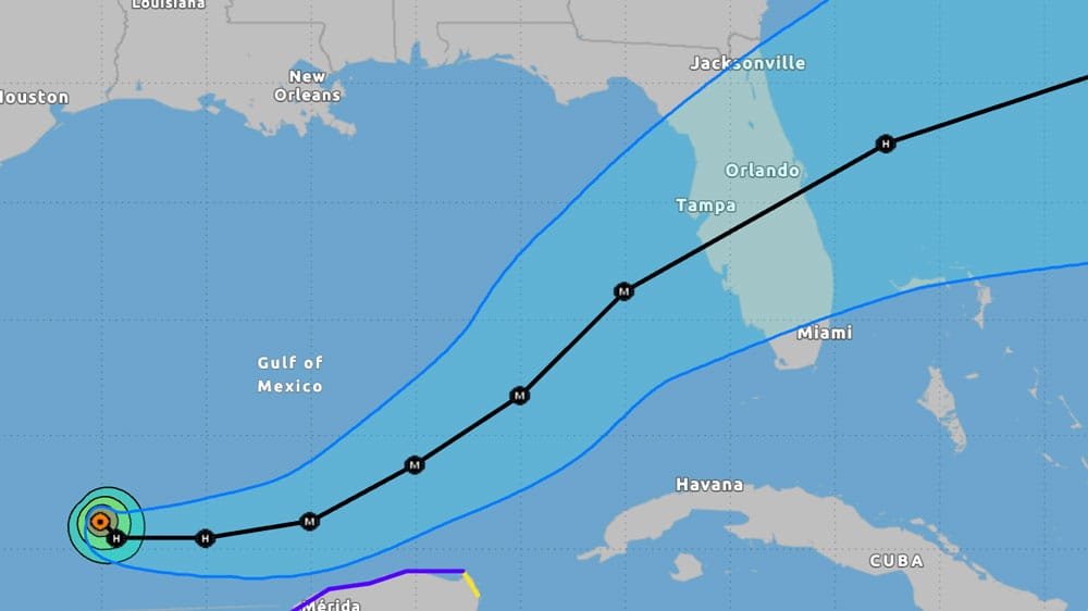 A weather map showing the projected path of a tropical storm or hurricane in the Gulf of Mexico, with markers indicating intensity and significant cities in Florida and surrounding areas.