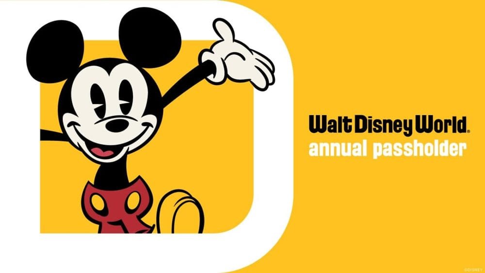 A cartoon character resembling a mouse with large ears and a smiling expression is waving. The background is yellow, and text reads "Walt Disney World annual passholder."