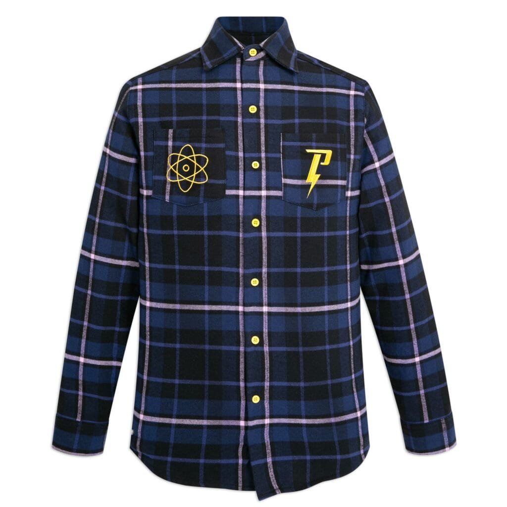 A blue and black plaid flannel shirt featuring two chest pockets; one with a yellow atom symbol and the other with a stylized yellow letter 'P' and lightning bolt design, all accented by yellow buttons.