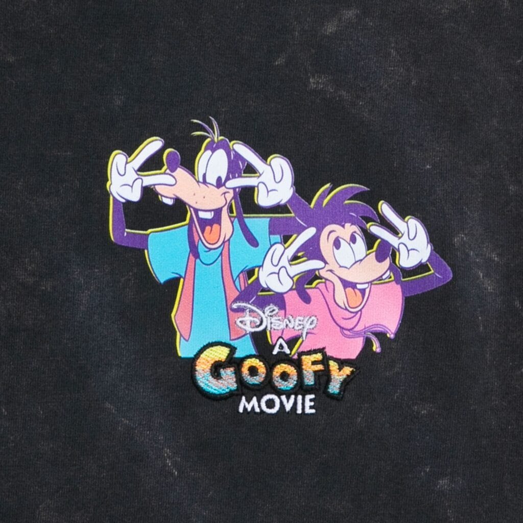 Graphic design featuring two animated characters from 'A Goofy Movie,' one with long ears and a blue shirt, and the other with a purple shirt, both making peace signs and smiling. The text 'Disney A Goofy Movie' is included below them, with a colorful design.
