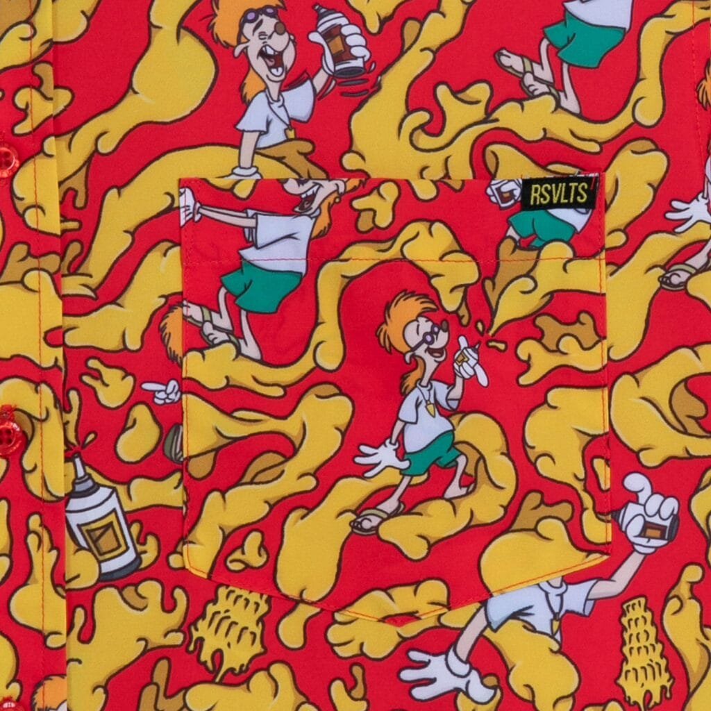 A colorful shirt featuring a unique cartoon pattern with playful characters on a vibrant red and yellow background, depicting animated figures engaging in humorous activities like spraying and eating, with a focus on the pocket area showing part of the design.