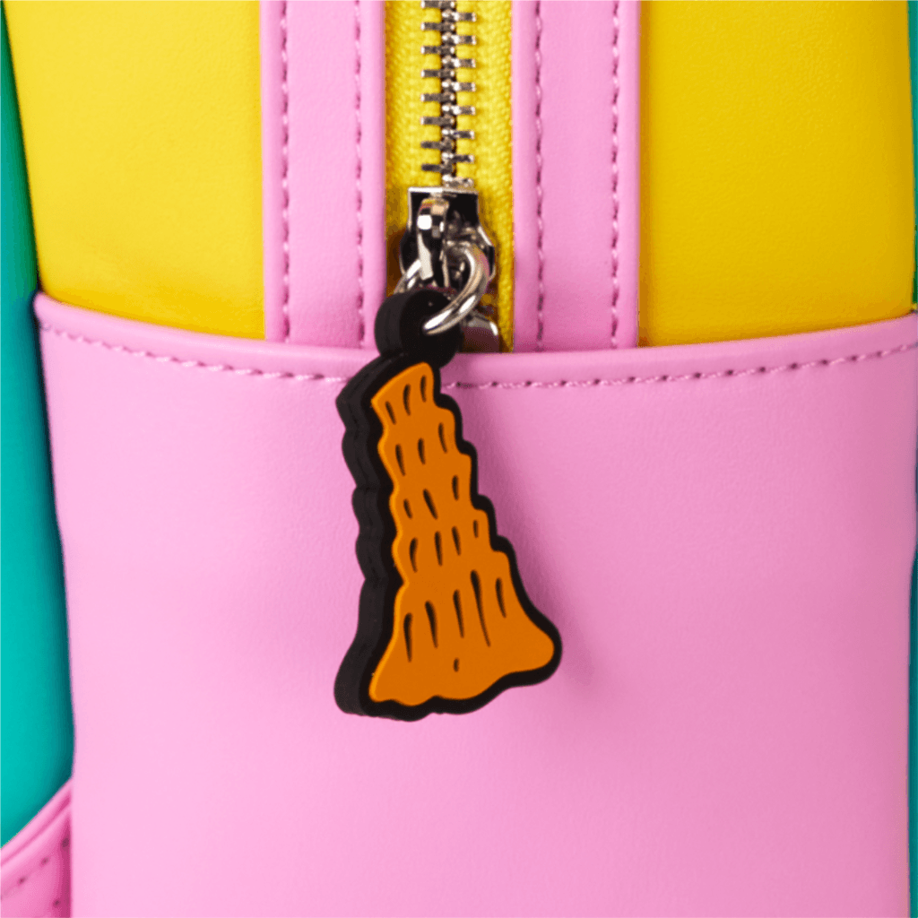 Close-up of a colorful bag featuring a bright pink section with a zipper and an orange, cartoonish tag shaped like a piece of food, hanging from the zipper pull.