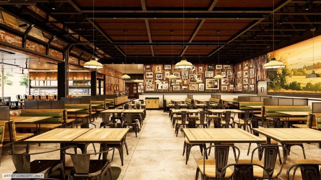An artist's concept of a spacious restaurant interior featuring wooden tables, black metal chairs, and green upholstered benches. The walls are adorned with framed photos and a vibrant mural depicting a countryside scene, while industrial-style light fixtures hang from the ceiling.